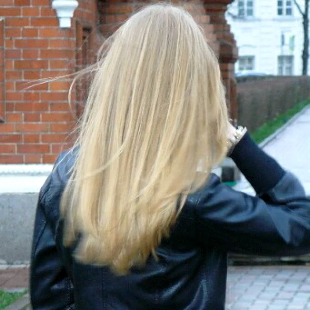 Блондинка с челкой и длинными волосами со спины