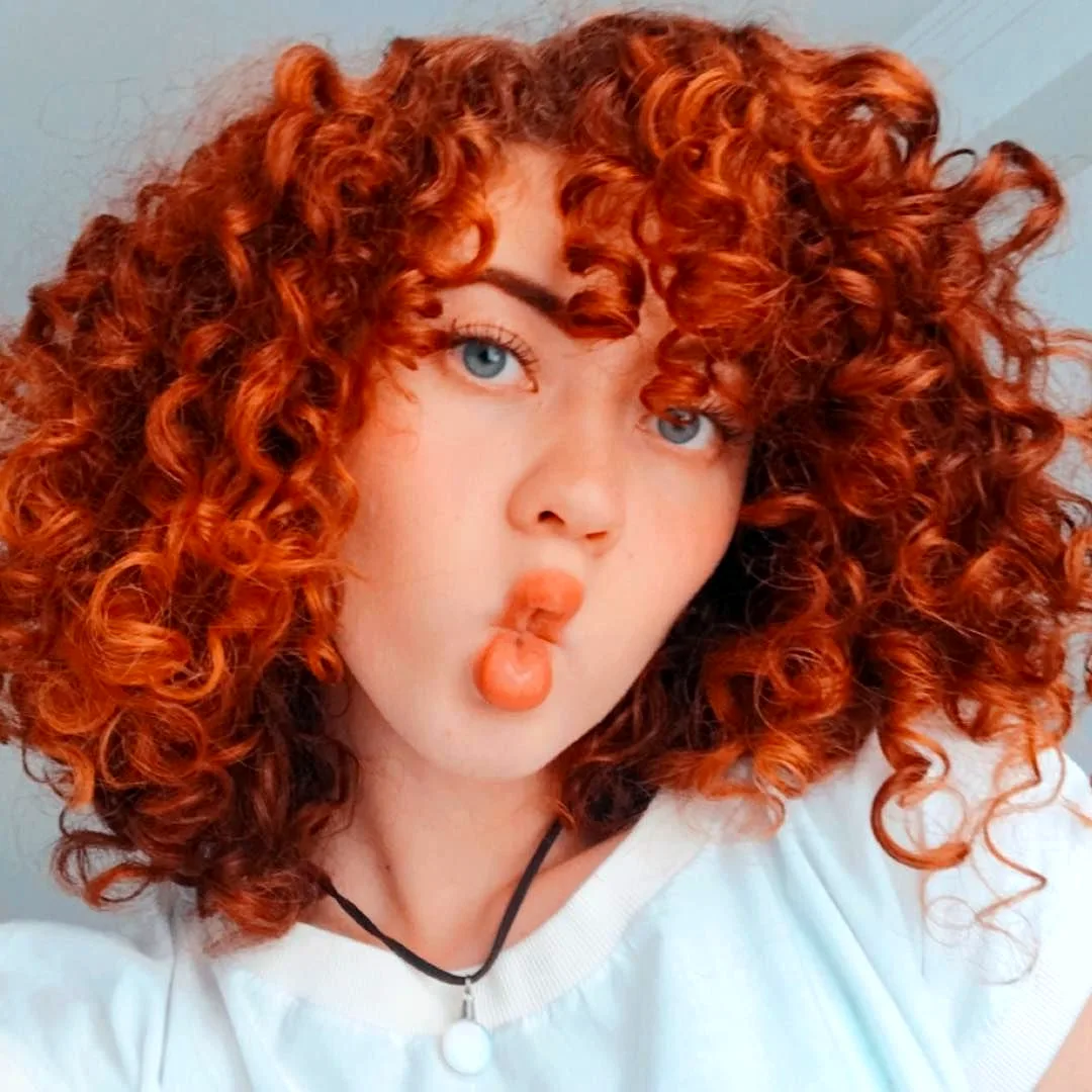 Девушка с короткими кудрявыми рыжими волосами